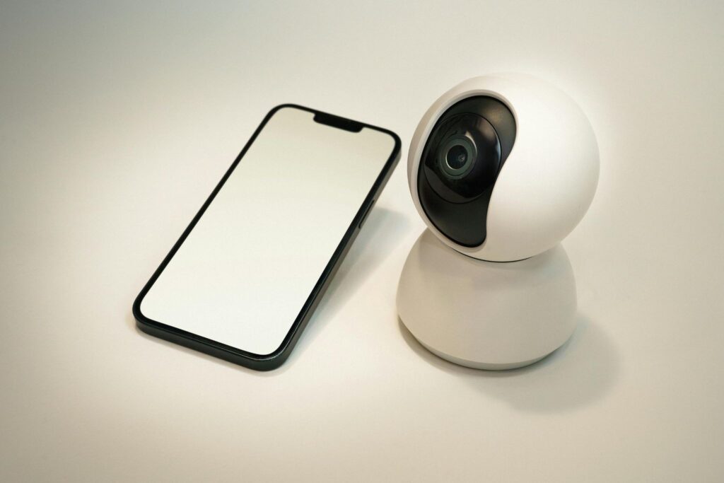Wireless smart security camera connected to smartphone for home monitoring.